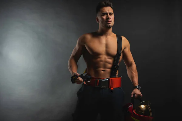 Portrait Muscular Handsome Firefighter Dark Background Holding Fire Helmet Looking — Stock Photo, Image