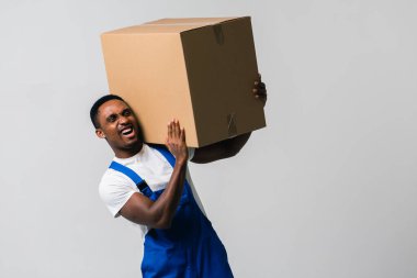 Karton kutulu bir kurye, mavi tulumlu genç bir Afro-Amerikalı ve beyaz tişörtlü karton kutu taşıyan bir adam. Beyaz bir arka planda izole edilmiş. Teslimat, posta, sevkiyat, forklift konsepti