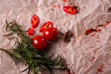 Assorted peppers and spices on a light parchment background. Seasonings for food. Homemade spices ingredients for cooking. Selective focus