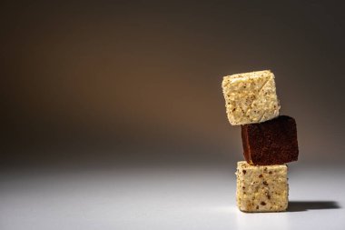 Beyaz ve çikolata parçalı kurabiyeler üst üste dizilmiş, piramit gibi, açık arkaplanda. Güzel kavram.