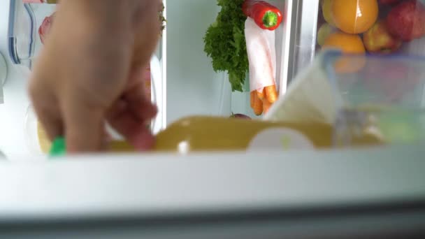 Woman opening the refrigerator door filled with food different food — Stock Video