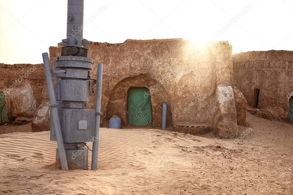 Abandoned set for the filming of Star Wars movie in the Sahara Desert against the backdrop of sand dunes.