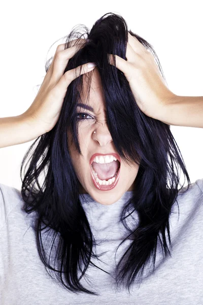 Young woman showing her anger and stress towards someone over a white background. — Stock Photo, Image