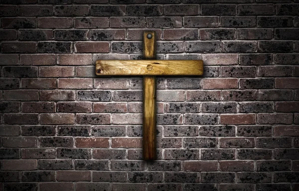 Wooden crucifix hanging on a brick wall. — ストック写真