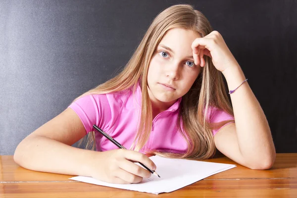 Girl studying at the desk Stock Image