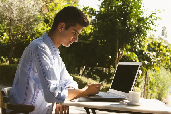 Man with mobile and laptop Royalty Free Stock Images