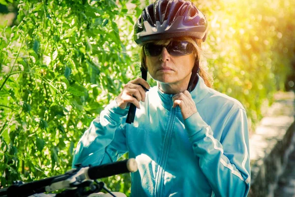 biker woman with helmet and bicycle