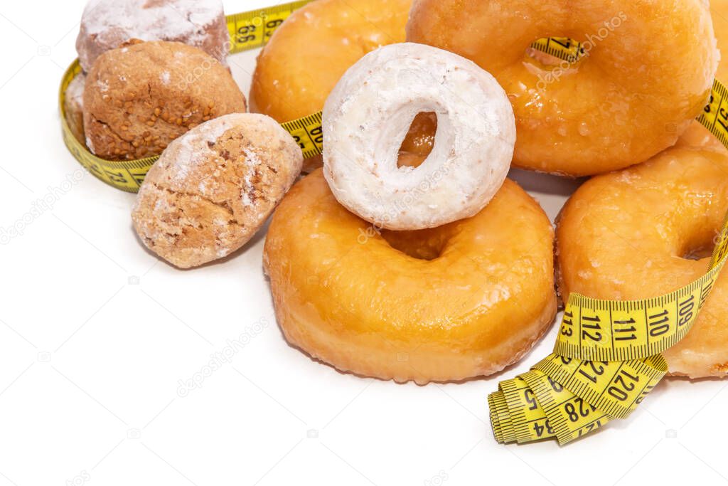 donuts and cakes with measuring tape isolated on white