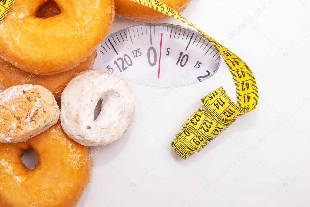 scale with tape measure and industrial pastries or sweets