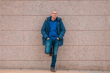 Sokak duvarında montlu son sınıf öğrencisi.