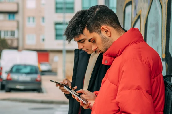 young people with mobile phone on the city street