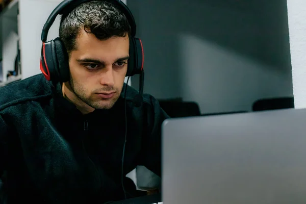 man with headphones and computer
