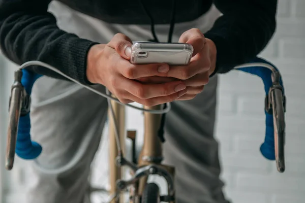 hands with mobile phone on the bicycle