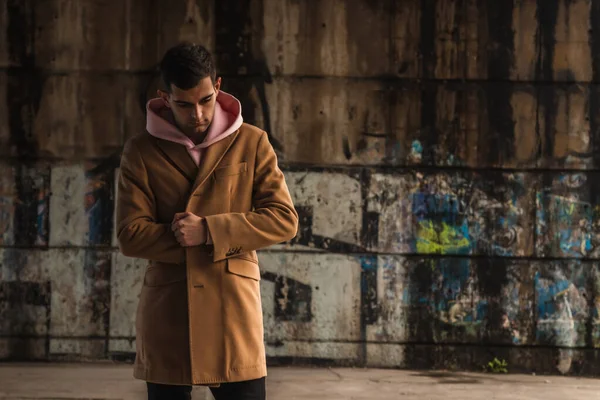 young man in coat on the street