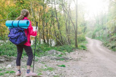 Yolda haritası olan bir kadın yürüyüş pratiği yapıyor.