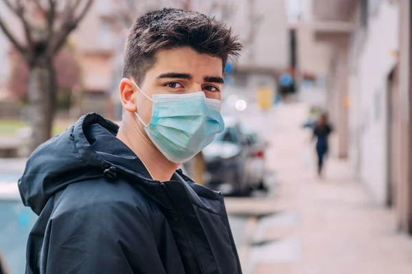 teenage boy with face mask on the street