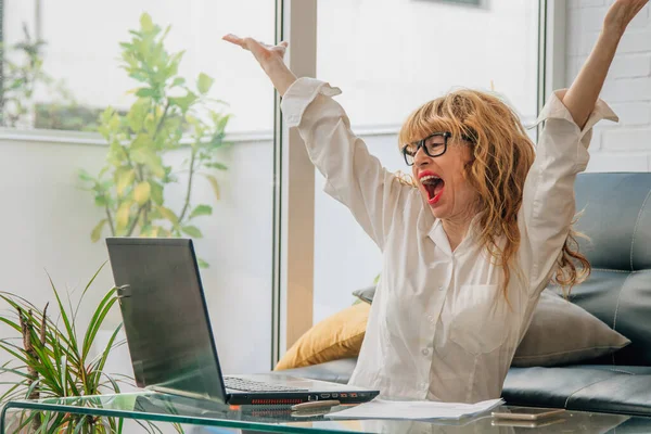 コンピュータに興奮してデスクで陽気なビジネスの女性 — ストック写真