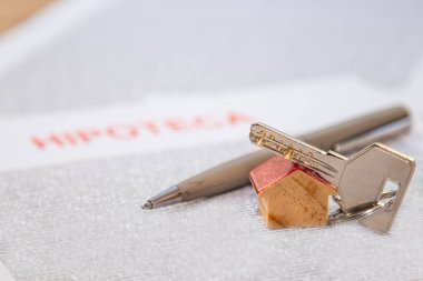 house keys on mortgage document. concept of buying a house