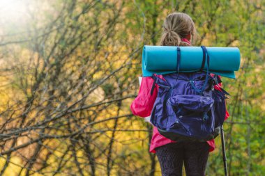 woman with backpack on her back in the mountains 