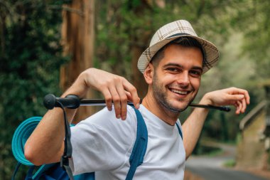 portrait of young man with backpack hiking or trekking