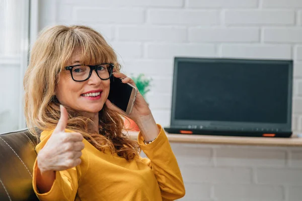 woman talking on the phone at home or in the office