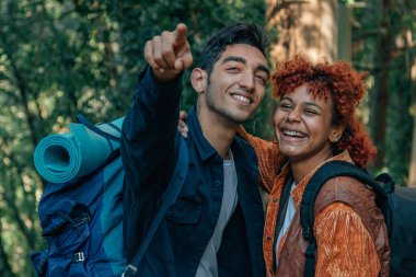 young couple with travel backpacks exploring the trail
