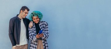 Cep telefonuna bakan çok ırklı genç bir çift