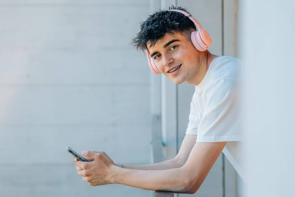 Έφηβος Αγόρι Κινητό Τηλέφωνο Και Ακουστικά Στο Μπαλκόνι — Φωτογραφία Αρχείου