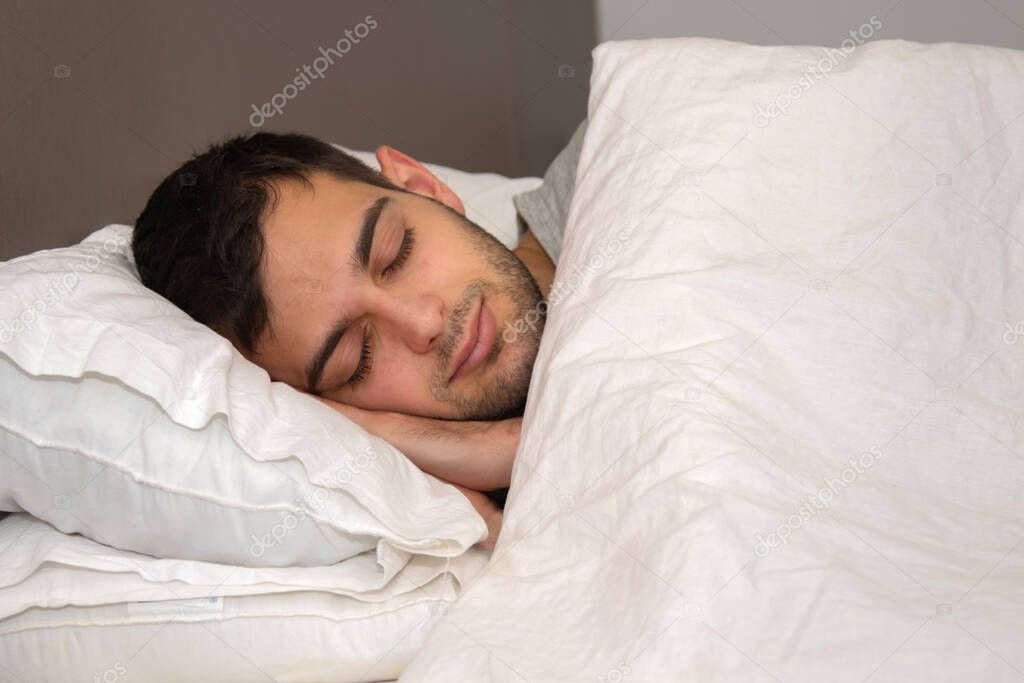 portrait young man sleeping in bed