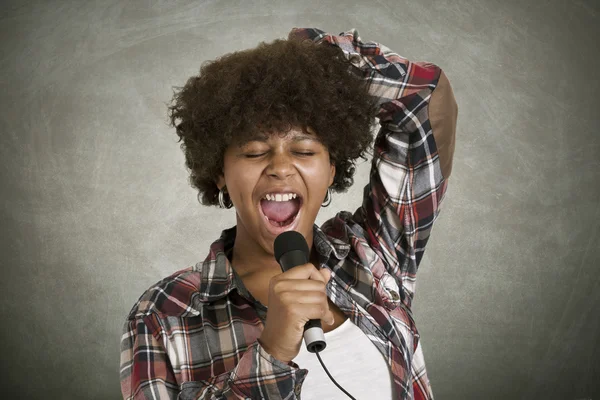 Girl with microphone singing — Stock Photo, Image