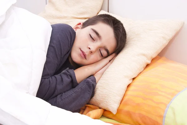 Child lying in bed — Stock Photo, Image