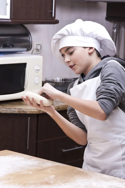 Criança com massa na cozinha — Fotografia de Stock