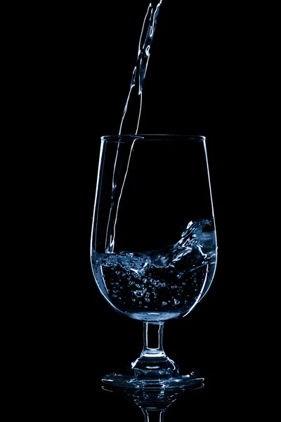 Pouring water on glass — Stock Photo, Image