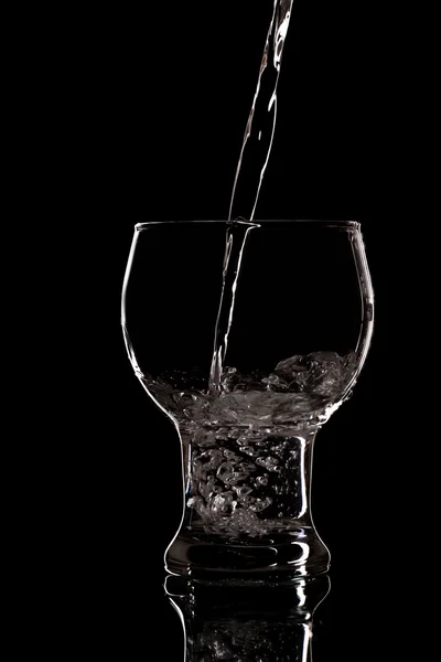 Pouring water on glass — Stock Photo, Image