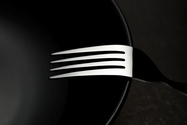 Forks and black dish — Stock Photo, Image