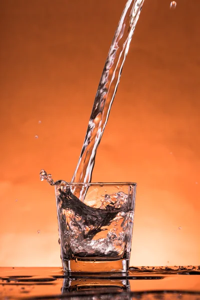 Water splash in a glass — Stock Photo, Image