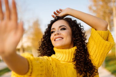 Yakın plan. Kafasını sevinçle fırlattı. Yukarı baktı. Avuç içiyle elini uzattı.