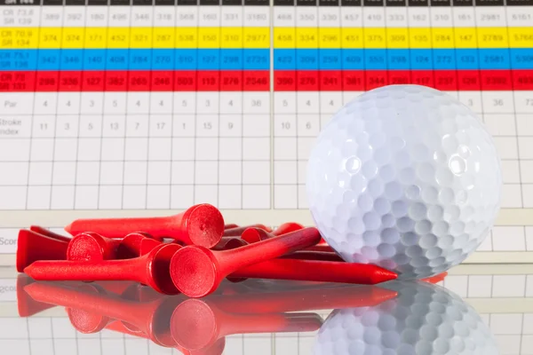 Golf score card and white ball on a glass desk — Stock Photo, Image