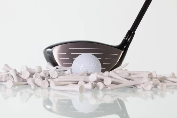 Golf driver and wooden tees on a glass desk — Stock Photo, Image