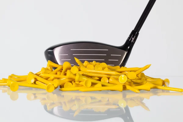 Golf driver and wooden tees on a glass desk — Stock Photo, Image