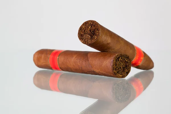 Different cigars on a  glass desk — Stock Photo, Image