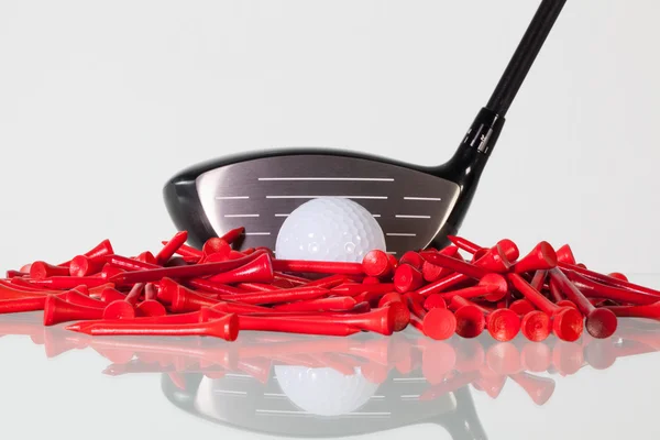 Golf driver and wooden tees on a glass desk — Stock Photo, Image