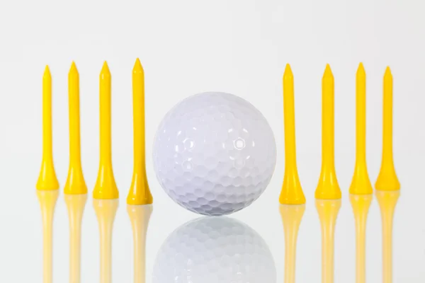 Bola de golfe e camisetas amarelas na mesa de vidro — Fotografia de Stock