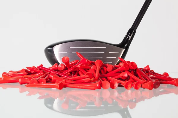 Golf driver and wooden tees on a glass desk — Stock Photo, Image