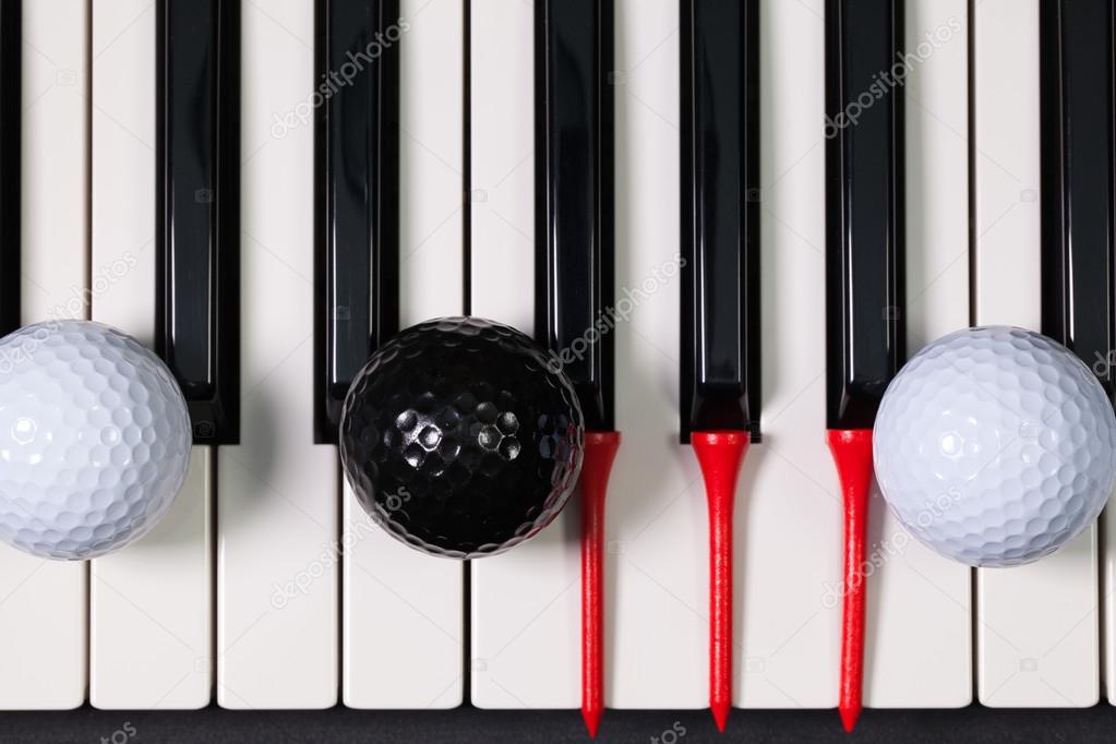 Piano keyboard and different golf balls and tees
