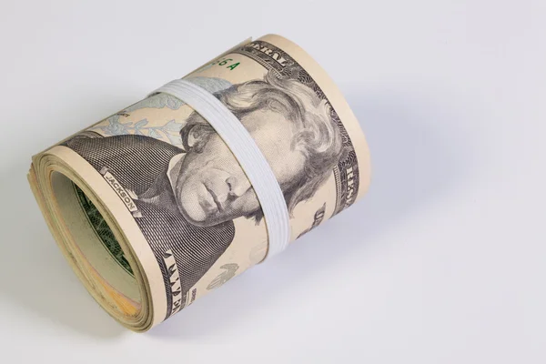 The roll of dollar bills with plastic band over the eyes — Stock Photo, Image