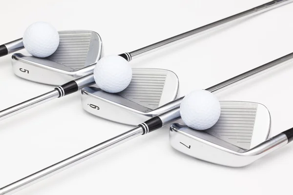 Titanium golf clubs on the white table — Stock Photo, Image