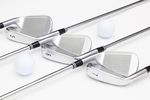 Titanium golf clubs on the white table — Stock Photo, Image