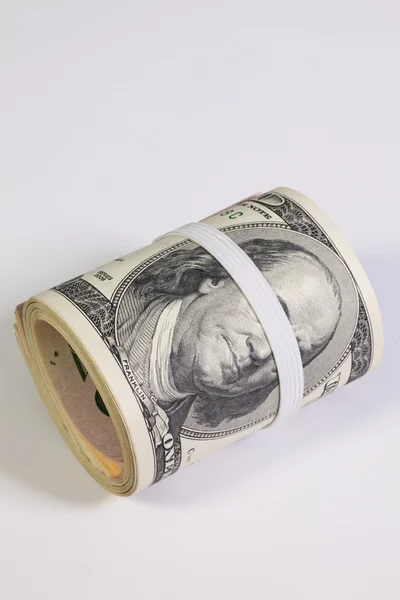 The roll of dollar bills with plastic band over the eyes — Stock Photo, Image