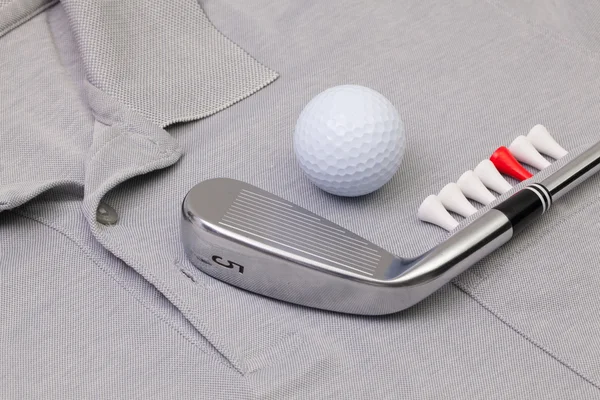 Grey polo shirt and golf equipments — Stock Photo, Image